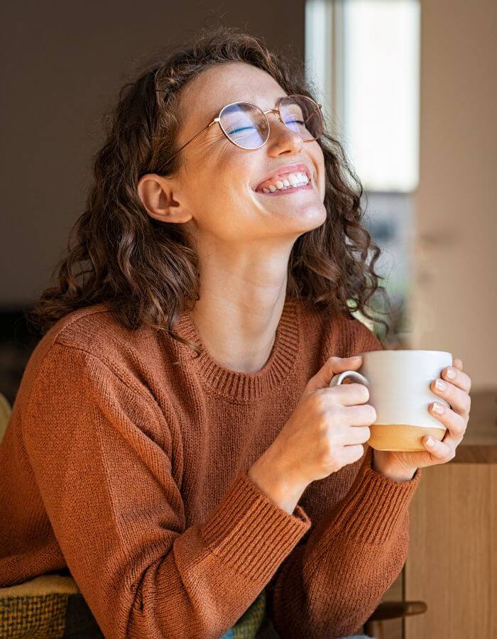 A person enjoying a calm moment with a warm drink.