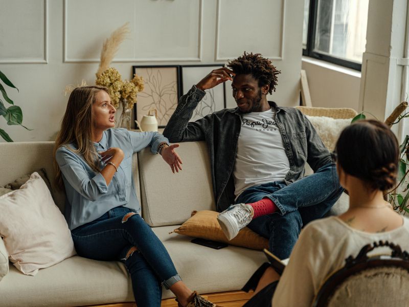 Two partners talking during a couples therapy session.