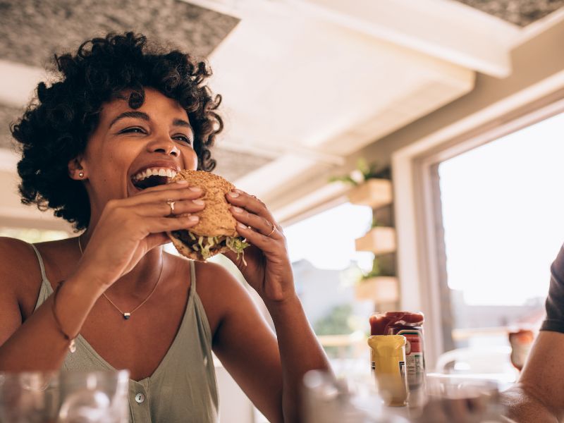 A person enjoying a meal in a relaxed social setting.